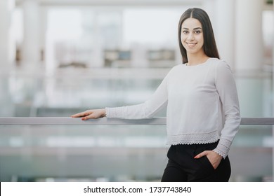 Happy, Female Intern Standing In The Office On Her First Day