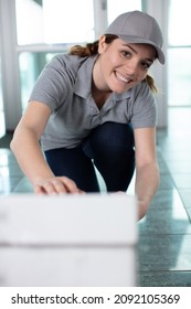 Happy Female Janitor Cleaning The Floor