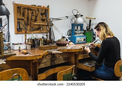 Happy female jeweler working in studio - Powered by Shutterstock