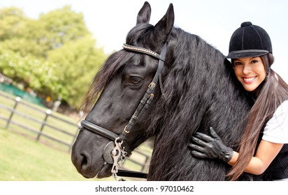 Happy female jockey riding a horse outdoors and smiling