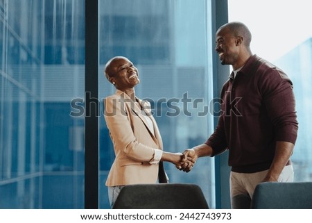 Similar – Image, Stock Photo Business black man in suit leaving the office holding his work briefcase and using smartphone