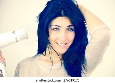 Happy Female Model With Blow Dryer