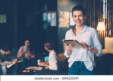 Happy Female Owner Of Successful Business Idea Standing With Digital Tablet Connected To Wifi In Office, Portrait Of Prosperous Smiling Female Entrepreneur Satisfied Of Being Leader Of Working Team