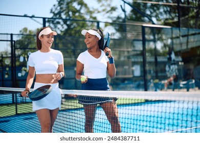 Happy female paddle tennis players communicating while leaving the court after playing a match. Copy space.  - Powered by Shutterstock