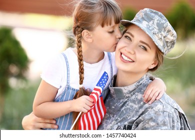 Happy female soldier with her daughter outdoors - Powered by Shutterstock