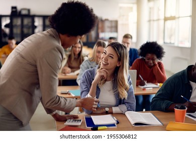 Happy Female Student Communicating With American American Professor During Lecture At The University. 