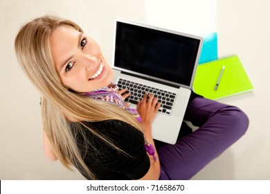 Happy Female Student With A Laptop And Notebooks