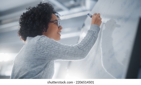 Happy Female Student Thinking About Solving Math Problem With Complicated Equation In Front Of Whiteboard. Education, Learning And Startup Internship Opportunity Concept.