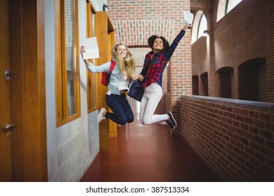 Happy Female Students Receiving Results At The University