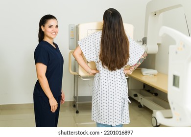 Happy Female Technician Smiling While Helping A Young Woman Get A Chest X-ray At The Medical Imaging Lab