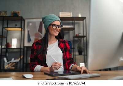 Happy Female Video Editor Works Indoors In Creative Office Studio.