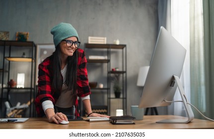 Happy Female Video Editor Works Indoors In Creative Office Studio.