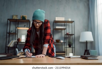 Happy Female Video Editor Works Indoors In Creative Office Studio.