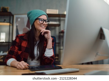 Happy Female Video Editor Works Indoors In Creative Office Studio.