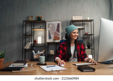 Happy Female Video Editor Works Indoors In Creative Office Studio.