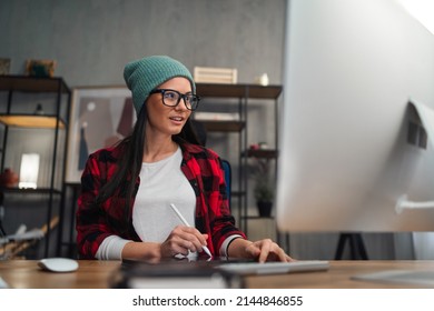 Happy Female Video Editor Works Indoors In Creative Office Studio