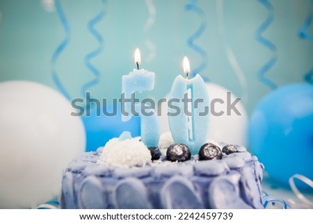 Happy fiftieth birthday navy cake and number fifty candle with blue balloons and decoration