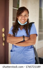 Happy Filipina Nurse Portrait In Front Of House