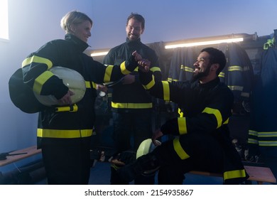 Happy Firefighters Men And Woman Talking After Action Indoors In Fire Station