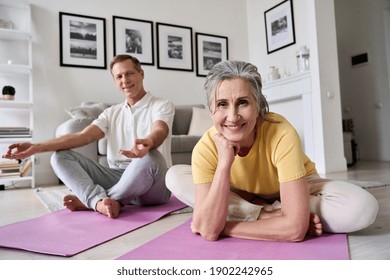 Happy fit middle aged woman exercising with husband at home,portrait.Smiling healthy old senior 60s couple meditating,doing yoga together at home,enjoying fitness activity posing on mats in apartment. - Powered by Shutterstock
