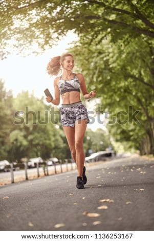 Similar – Fit healthy athletic woman jogging on a river bank