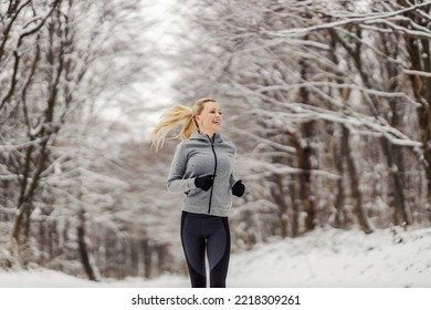 Happy Fit Sportswoman Jogging In Woods At Snowy Winter Day. Outdoor Fitness, Winter Fitness, Healthy Lifestyle