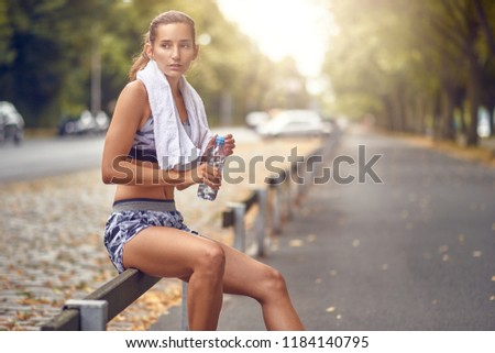 Similar – Happy fit woman taking a break from jogging