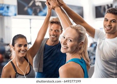 Happy Fitness Class Giving High-five After Completing Exercise Session. Group Of Sporty People Giving High Five And Looking At Camera. Smiling Friends Celebrate Their Success.