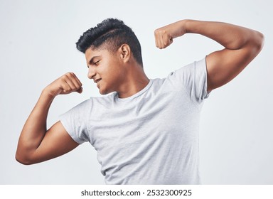 Happy, fitness and man flexing arms in studio for muscle, strength and body building training. Confident smile, sports pride and young male student showing biceps isolated by white background - Powered by Shutterstock