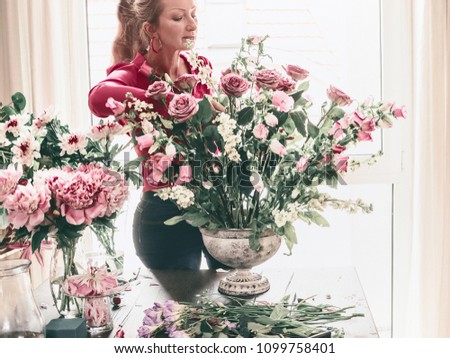 Woman makes festive bouquet with vase