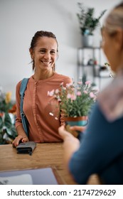 Happy Flower Shop Customer Enjoying In Buying Flowers.