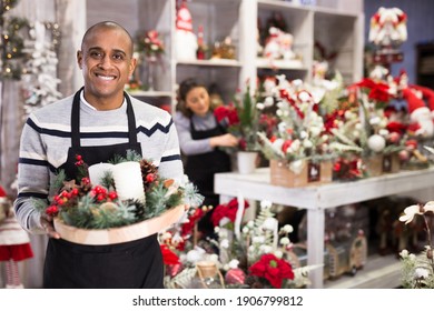 Happy Flower Shop Owner Holding Christmas Composition