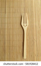 Happy forks on wood texture of dining table. Concept about happiness and waiting for someone.