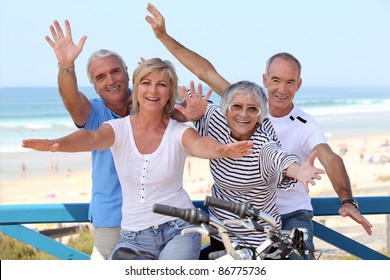 happy foursome gone for a ride by oceanfront - Powered by Shutterstock