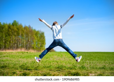 happy free boy who is jumping against the blue sky
