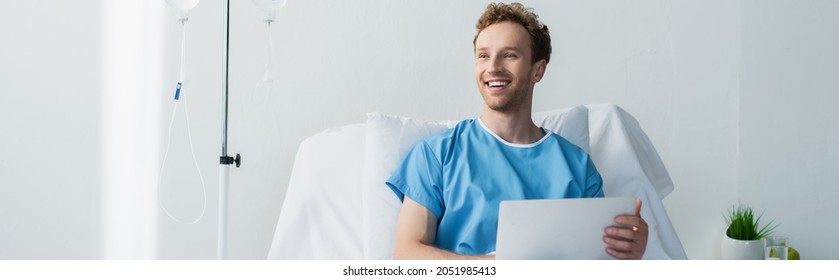 Happy Freelancer In Patient Gown Using Laptop In Hospital Bed, Banner