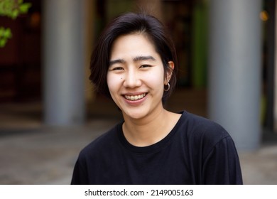 Happy friendly asian non-binary LGBT person smiling to camera - Shutterstock ID 2149005163