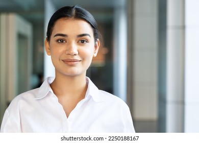 Happy and friendly south asian, Indian woman office worker looking and smiling at you - Powered by Shutterstock