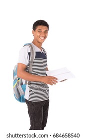 Happy friendly teenage boy with backbag smiling and holding a notebook, teenager wearing striped gray t-shirt and black jeans,  isolated on white background