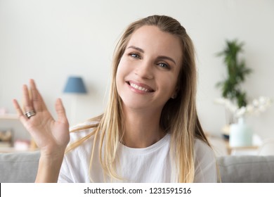 Happy friendly woman waving hand looking at camera webcam, smiling millennial lady vlogger recording vlog or making video call at home, lifestyle vlogging, dating online concept, headshot portrait