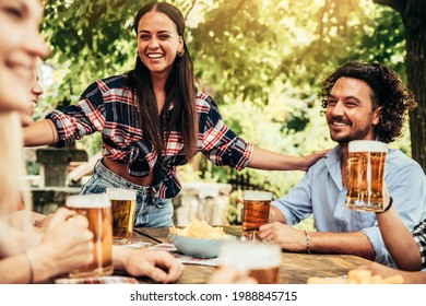 Happy Friends Celebrating Drinking Beer Pint At Park Outdoor - Young People Talking And Laughing Together At Brewery Pub Garden - Friendship, Youth And Beverage Concept