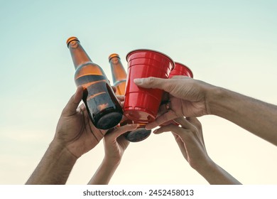 Happy friends cheering and drinking cheering beer at beach party outdoor. people vacation holiday on beach. Summer holiday having fun relax vacation time with sunset - Powered by Shutterstock