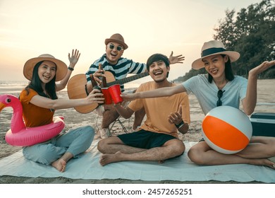 Happy friends cheering and drinking cheering beer at beach party outdoor. people vacation holiday on beach. Summer holiday having fun relax vacation time with sunset - Powered by Shutterstock