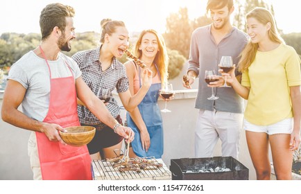 Happy Friends Cooking And Drinking Wine At Patio Barbecue Dinner - Trendy People Preparing Meat With Bbq Sauce - Youth Lifestyle, Food, Friendship And Summer Concept - Main Focus On Left Man Face
