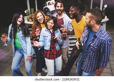 Happy Friends Dance At Backyard Party - Good And Positive Mood Of Millennials People Having Fun Dancing And Drinking Wine, Cocktails And Beers On Courtyard Of The Beach Bar In The Afternoon