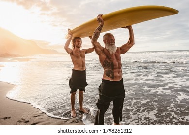 Happy Friends With Different Age Surfing Together On Tropical Ocean - Sporty People Having Fun During Vacation Surf Day - Elderly And Youth People And Extreme Sport Lifestyle Concept