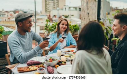 Happy Friends At Dinner Party Outside, Interracial Group Of People Having Fun Together Drinking Wine Laughing And Enjoying Holidays, Positive People Dining Together, Friends Celebrating Rooftop Party 