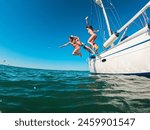 Happy friends diving from sailing boat into the sea - Travel and summer vacation concept - Soft focus on blond girl face