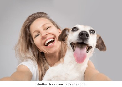 Happy friends dog and woman. Cute funny friends. focus on the face of a woman, muzzle of dog in defocus. Happy exited portrait of blonde dog owner girl and her adorable Jack Russell terrier pet  - Powered by Shutterstock