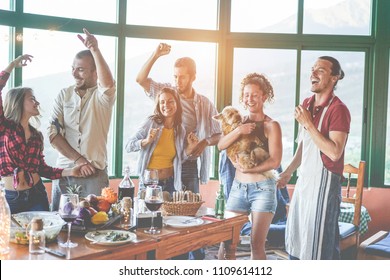 Happy Friends Doing Vegetarian Party Dinner At Home - Adult People Having Fun Drinking And Eating Together - Focus On Glasses Bottles - Healthy Lifestyle, Millennial Generation And Friendship Concept